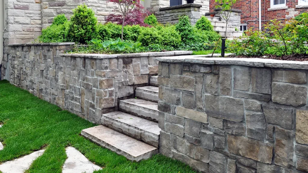Gray-Stone-retaining-wall-in-a-yard-with-shrubs-1428028431